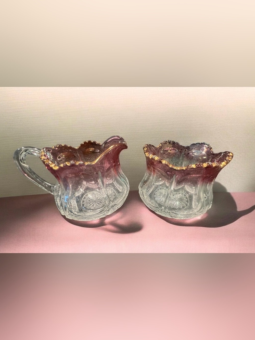 EAPG ruby flashed glass pitcher and holder with scalloped rim and cut patterns.